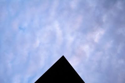 Low angle view of building against cloudy sky