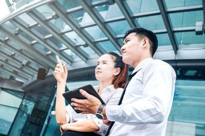 Young woman using mobile phone in office