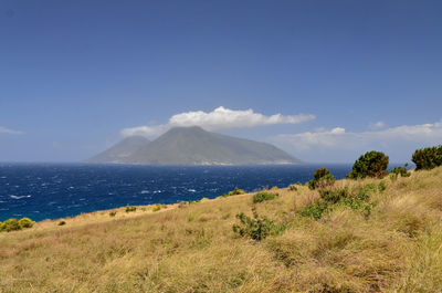 Scenic view of mountains against blue sky