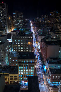 Aerial view of city lit up at night