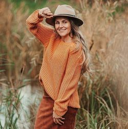 Young woman wearing hat standing on land