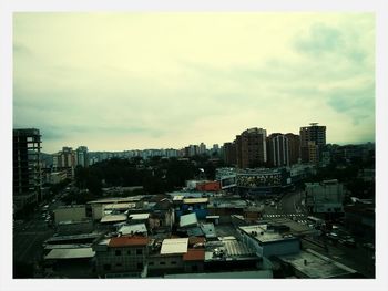 Cityscape against cloudy sky