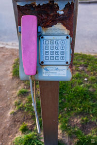 Close-up of telephone booth on field