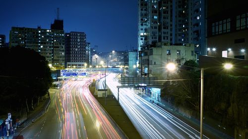 Light trails on city street at dusk