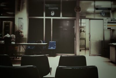 Empty chairs and table in room