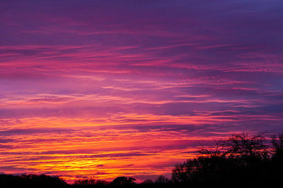 Silhouette landscape against romantic sky at sunset