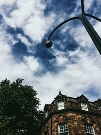 Low angle view of building against cloudy sky