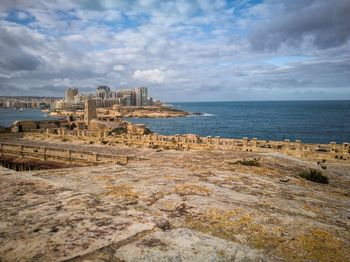 Scenic view of sea against cloudy sky