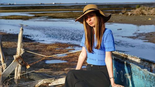 Woman wearing hat standing at beach