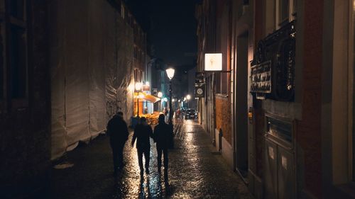 People in illuminated city at night