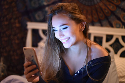 Beautiful young woman smiling using smart phone 