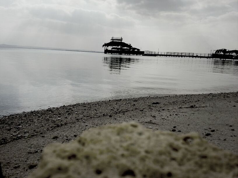 water, sea, beach, sky, shore, tranquility, tranquil scene, sand, reflection, nature, scenics, pier, beauty in nature, horizon over water, cloud - sky, built structure, calm, nautical vessel, idyllic, boat