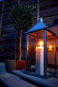 Close-up of illuminated lamp on table