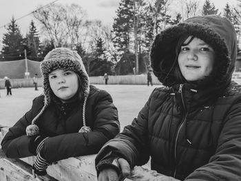 Portrait of twins at skating rink in winter