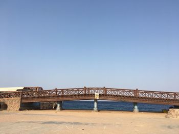 View of beach against clear blue sky