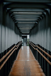 Rear view of man walking on escalator