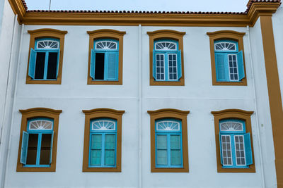 Low angle view of yellow windows on building