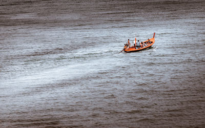 High angle view of people in boat sailing on sea