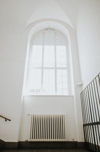 Low angle view of white wall in building