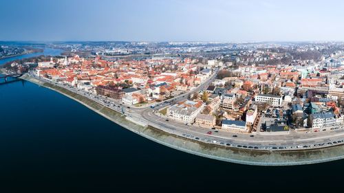 High angle view of buildings by sea against sky