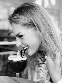 Close-up portrait of woman drinking glass