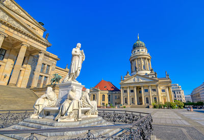 Statue of historic building against blue sky