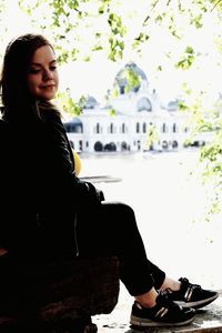 Young woman sitting outdoors