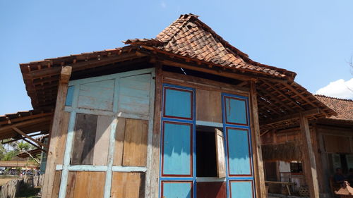 Low angle view of old building against blue sky