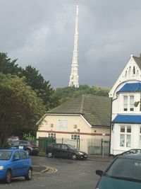 Cars on street against sky