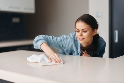 Portrait of young woman sitting at home