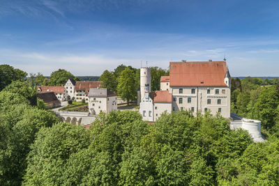 High angle view of trees and buildings against sky