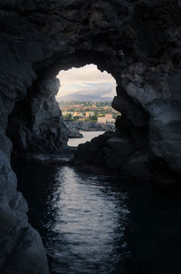 Scenic view of sea seen through cave