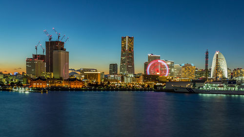 Illuminated city at waterfront