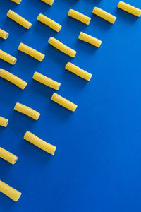 High angle view of yellow and blue buttons against black background