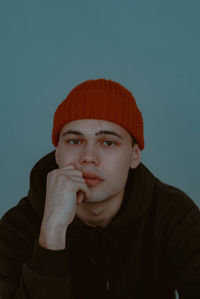 Portrait of young man against gray background