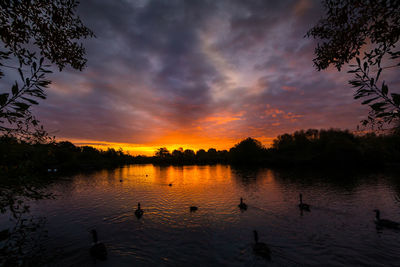 Scenic view of lake against sky during sunset