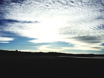 Scenic view of silhouette field against sky