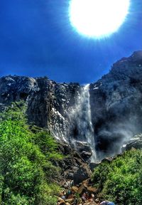 Scenic view of waterfall against sky