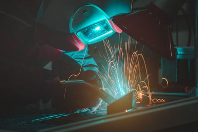 Low angle view of illuminated lighting equipment in factory