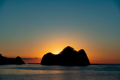 Scenic view of sea against clear sky during sunset