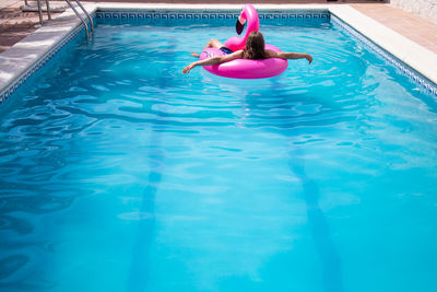 High angle view of woman swimming in pool