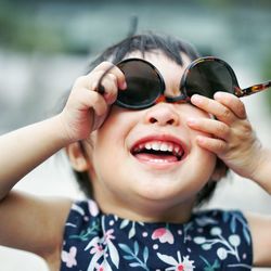 Close-up portrait of cute girl wearing sunglasses