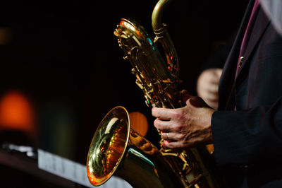 Midsection of musician playing saxophone