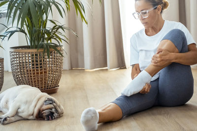 Side view of man sitting on sofa at home