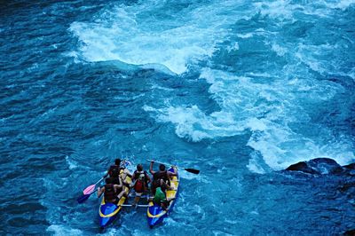 High angle view of people river rafting