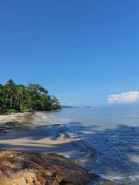 Scenic view of sea against blue sky