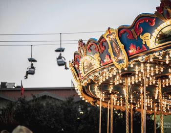 Illuminated carousel against sky