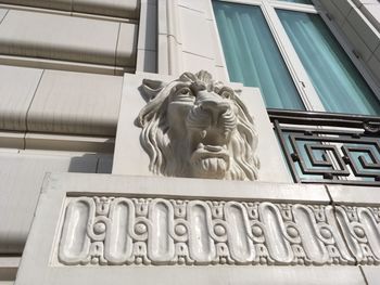 Low angle view of statue against building