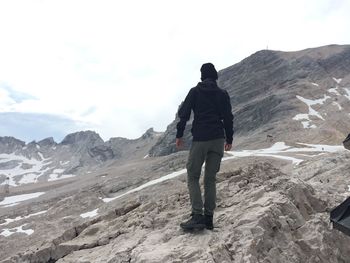 Rear view of man standing on mountain