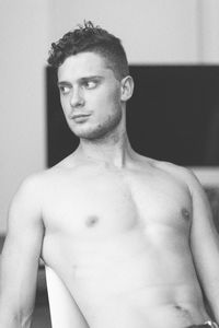 Portrait of shirtless man looking away